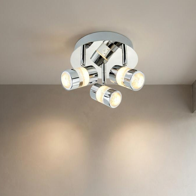 Bubbles LED 3 Light Chrome Adjustable Spotlight on a ceiling, casting warm light on a neutral-toned wall.