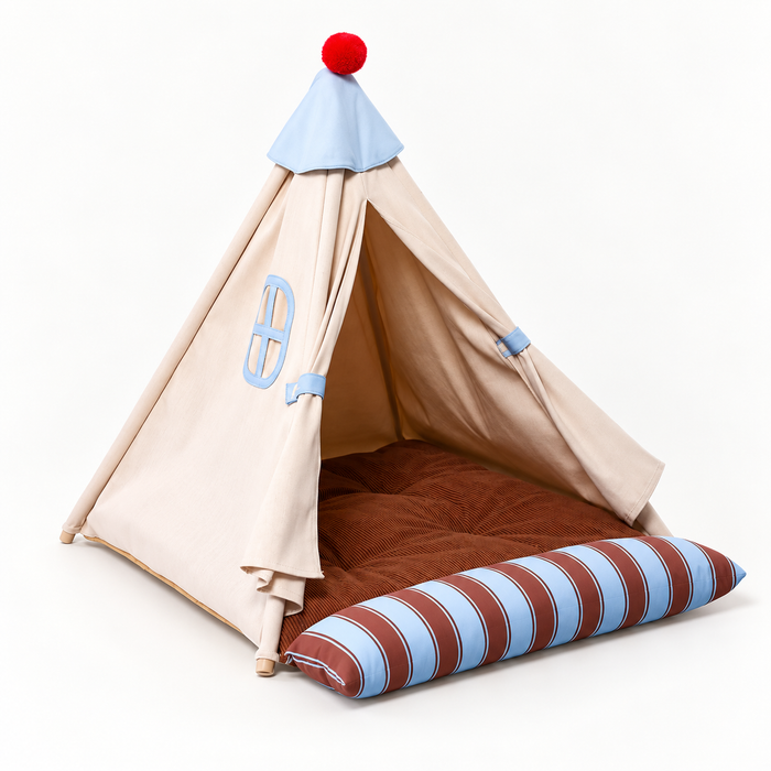 Beige semi-enclosed pet tent bed with blue trim, brown cushion, and striped bolster