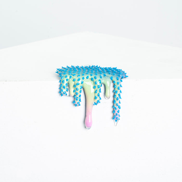 The Mini #19 by Dan Lam is a blue-tipped, spiky 3D piece resembling resin melting in pastel shades over a white edge, with a droplet extending gracefully downward.