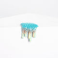 Dan Lams Mini #27 features a turquoise-to-beige gradient resembling upside-down icicles or dripping paint with spikes, set against a white background and crafted to mimic hot glue.