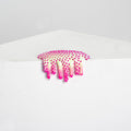 The Dan Lam Mini #29 by the brand Dan Lam is a clear plastic patch that looks like resin, featuring pink/white dots and drips, decoratively hanging over a white surface corner against a plain grey background.
