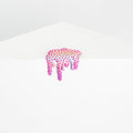 The artwork Mini #34 by Dan Lam showcases a white surface with a pink and green spiky, abstract shape that resembles a dripping resin form. The pale gray background provides a minimalist contrast, enhancing the vibrant foreground design.