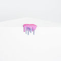 Dan Lams Mini #38 is a pink and silver drip-shaped resin creation with a textured, beaded surface on a white geometric base set against a light gray background, giving the appearance of melting or dripping over the edge.