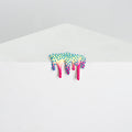 Dan Lams Mini #41 is an acrylic art piece resembling melting ice cream with a tree-like top in blue and green transitioning to bright pink drips, set against a simple gray and white background.
