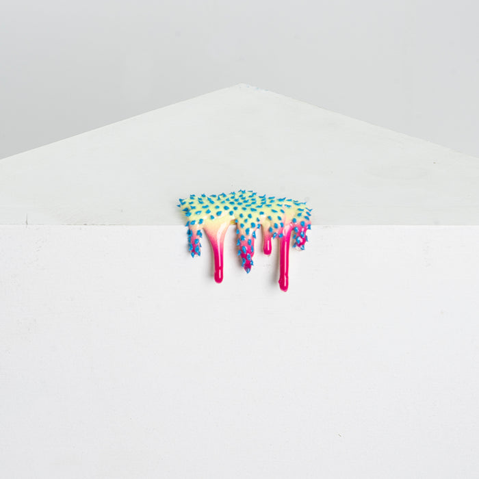 Dan Lams Mini #41 is an acrylic art piece resembling melting ice cream with a tree-like top in blue and green transitioning to bright pink drips, set against a simple gray and white background.
