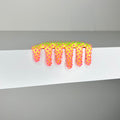 In 2023, Dan Lams Mini #654 adhesive tape, with a vibrant dripping paint design and pink star patterns, is applied to a smooth white surface.