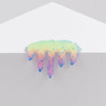 Dan Lams Mini #7.30 features a small, iridescent, cloud-like form on a white surface with colorful dripping tendrils in shades of pink, purple, and blue. The understated elegance is enhanced by the plain light gray background.