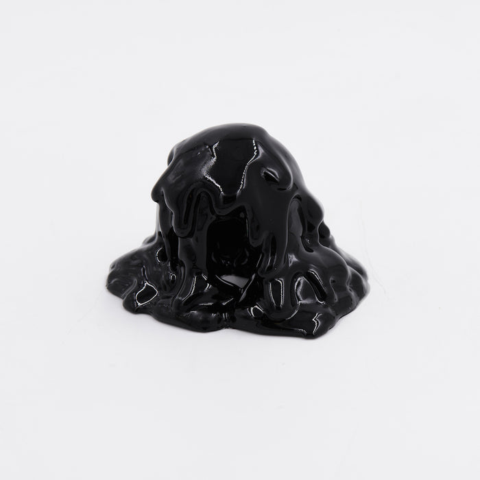 The Dan Lam - Mini #7.91 by Dan Lam is a glossy black creation, similar to molten resin, that forms a small mound on a white surface. Its thick and viscous texture shines with smooth, reflective surfaces, resembling dark acrylic in motion.