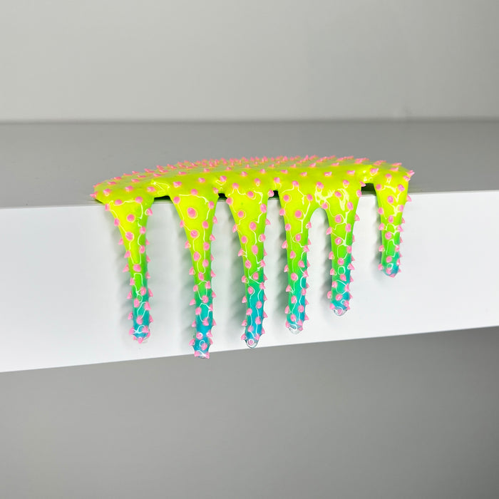 Dan Lams Mini #859 features a vibrant, neon spiky slime in a mixed media style, dripping over a white surface. Its glossy gradient transitions from yellow to green, with pink spikes scattered throughout, capturing the playful creativity of 2023.