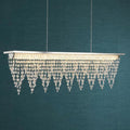Drape LED ceiling bar light with polished chrome and cascading crystals against a dark teal background.