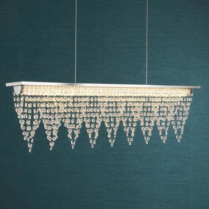 Drape LED ceiling bar light with polished chrome and cascading crystals against a dark teal background.