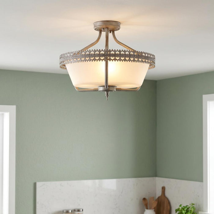 Iron grey 3-light semi-flush ceiling light with a decorative crown trim and frosted glass bowl in a green room.