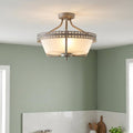 Iron grey 3-light semi-flush ceiling light with a decorative crown trim and frosted glass bowl in a green room.