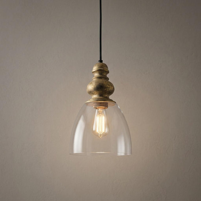 Elegant pendant light with a driftwood gold finial and clear glass bell shade, showcasing a warm vintage bulb.