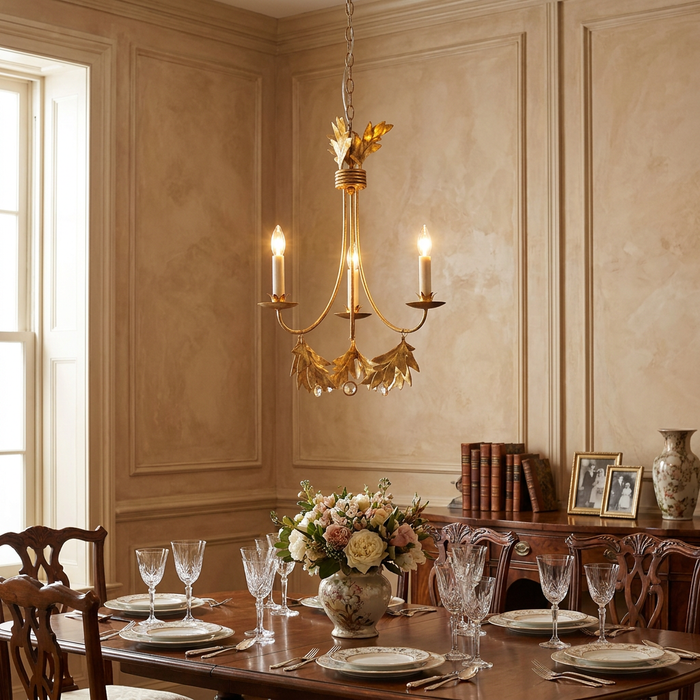 Flambeau Sweet Olive 3-light gilded gold chandelier with leaf accents hanging in an elegant formal dining room.