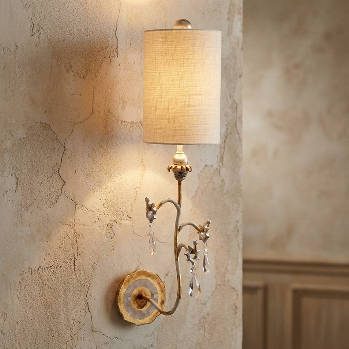 Flambeau Tivoli gold and cream wall light with crystal accents on a textured wall.