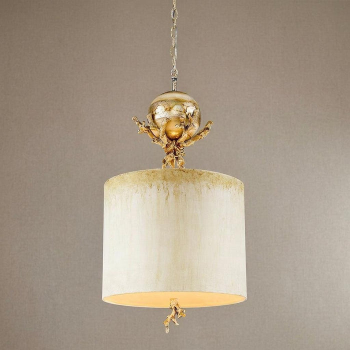 Elegant pendant light with cream drum shade, gold coral accents, and a silver orb against a neutral background.