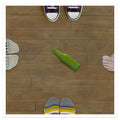 Four people stand in a circle on a wooden floor, with a green bottle lying on its side in the center—evoking a game of spin the bottle. Only their feet are visible, each in different footwear. This evocative scene is featured in Gabe Langholtz’s archival pigment print, "Spin," available as a signed and numbered limited edition from Gabe Langholtz.