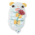 The Gussie Dog with Carnation by Katie Kimmel from Hashimoto Contemporary is a charming ceramic sculpture of a light blue dog-like creature. It holds a red rose and has large eyes, an orange nose, yellow-tipped ears, paws, and tail with its tongue playfully sticking out.
