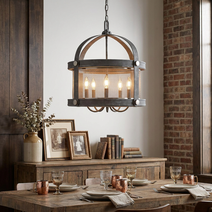 Aged zinc five-light chandelier with wire mesh drum hanging over a rustic dining table in a cozy home setting.