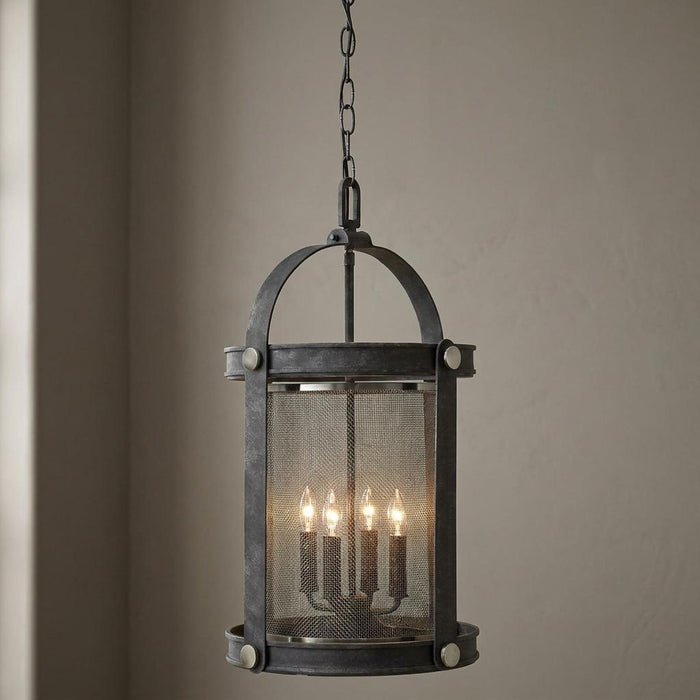 Industrial zinc lantern with a fine mesh screen and four glowing candle-style bulbs hanging from a chain.