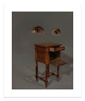 The captivating Open Conversation print by Lola Gil is a surreal, signed, and numbered edition. It showcases floating eyes above a vintage wooden nightstand with an open drawer against a muted background, enhancing its mysterious and dreamy atmosphere.