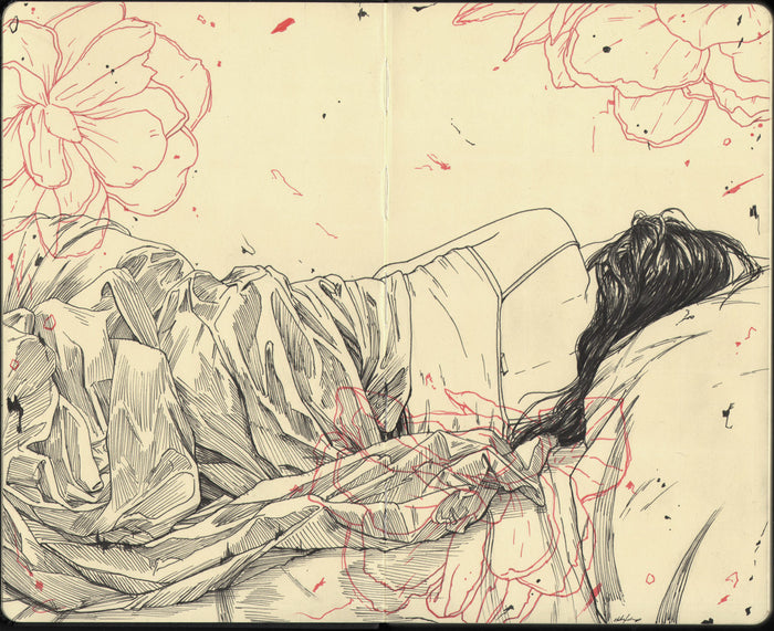 The Sunday Morning illustration by Zachary Oldenkamp captures a serene scene of a person lying on their side, wrapped in a blanket. Delicate pen and ink lines depict their long hair spread across the pillow, with red floral patterns blending into the monochrome theme on Moleskine pages.